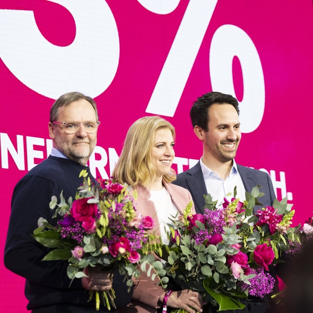 Beate Meinl-Reisinger Christoph Wiederkehr Sepp Schellhorn alle teil der neuen Regierung in österreich 2025 lächeln im foto mit blumen